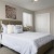 carpeted bedroom with large closet and bright windows